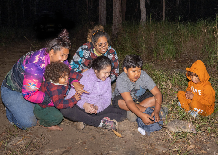 Gugu Badhun Traditional Owners joined AWC for the translocation. Pictured releasing a bettong are Araluen Hoolihan with children Oceann, Taylen and Emily, along with Shannon Gertz and daughter Ella.